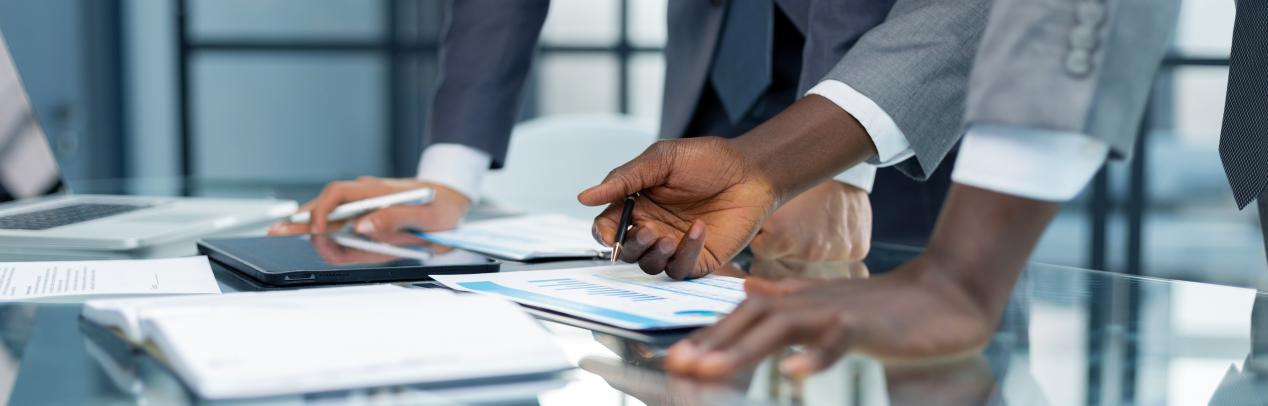 Hands of white and black business people as they work